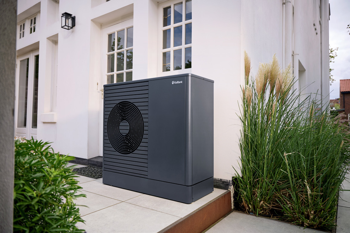 Air-source heat pump beside a residential home